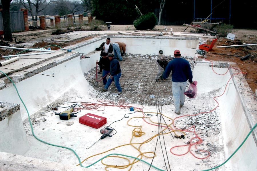 men-working-back-yard-stone-residential-pool-tyler-tx